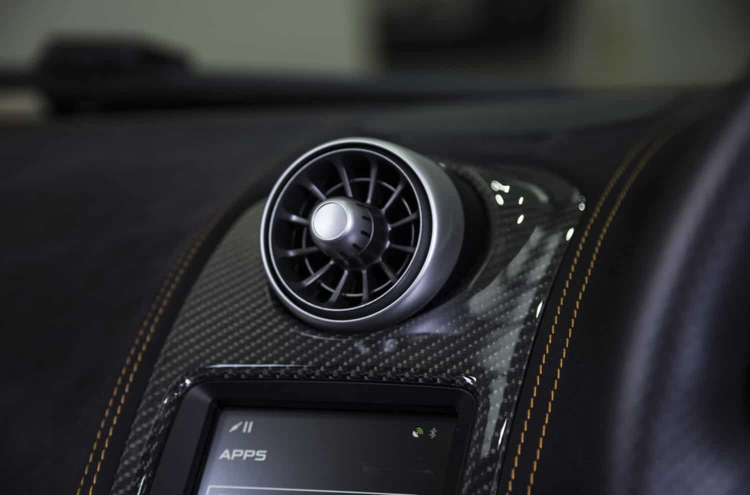 stock-photo-a-closeup-shot-of-car-aircon-on-a-black-dashboard-in-a-car-1733096681