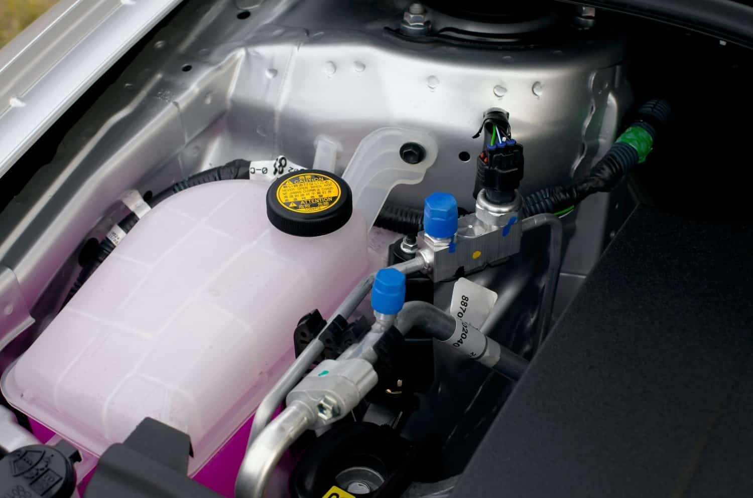 stock-photo-coolant-container-in-a-car-s-engine-bay-131891621
